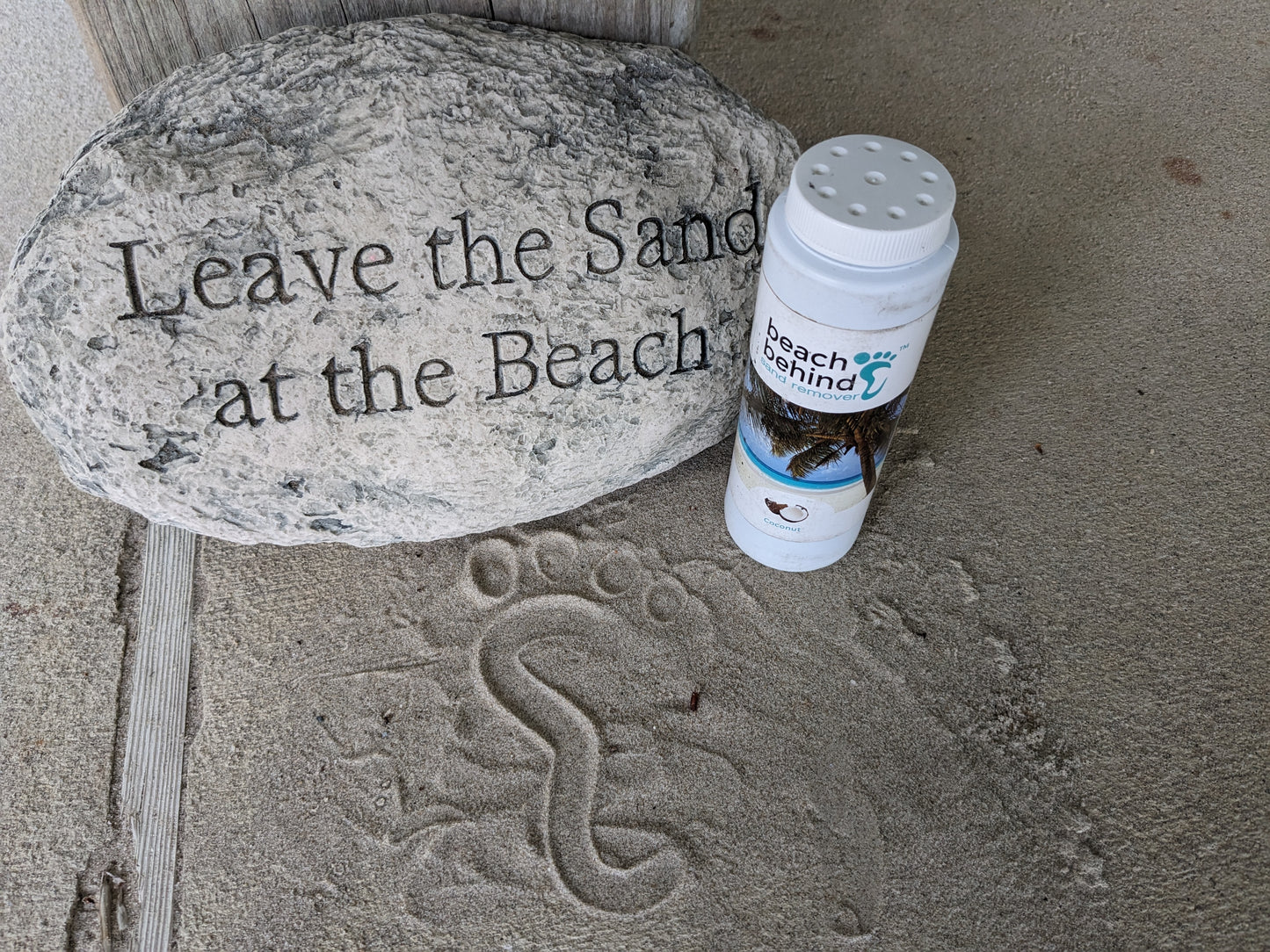 Welcome to our beach house sign that says leave the sand at the beach with a bottle of beach sand remover